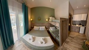 a small room with two beds and a kitchen at ΑVLI Sarti Studios & Apartments no 3 in Sarti