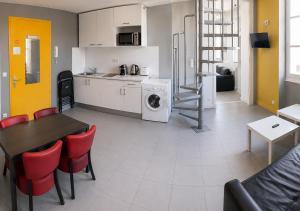 a kitchen and living room with a table and a washing machine at Les Appartements Carré d'or - Nice Centre in Nice +36 photos