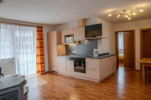 a kitchen with a stove top oven in a room at Ferienwohnung Schretthauser in Bad Mitterndorf