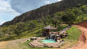 a resort with a water park with a waterfall at Pousada Carraro in Delfinópolis