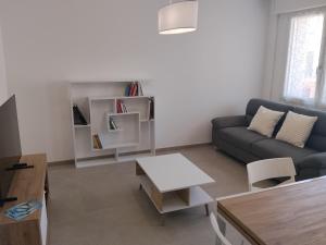 a living room with a couch and a table at Venice Delta Lagoon Apartments in Porto Viro