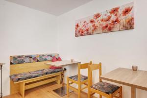 a dining room with a table and two chairs at Rienznerhof Natureplace in Montagna +65 photos