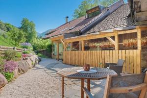 a patio with a table in front of a building at Rienznerhof Natureplace in Montagna