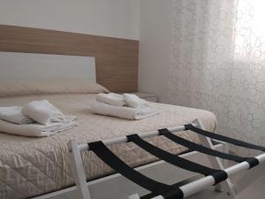 a bedroom with a bed with white towels on it at Venice Delta Lagoon Apartments in Porto Viro