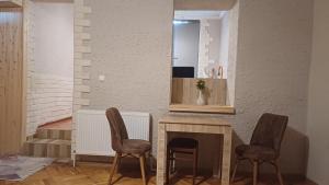 a living room with two chairs and a fireplace at Eco Cottage Rose in Borjomi +34 photos