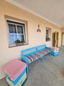 a room with three blue benches and a window at Apartmany Detvanka in Bački Petrovac +25 photos