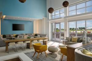 a living room with a couch and a table and chairs at Element by Marriott Pooler Savannah Airport in Savannah