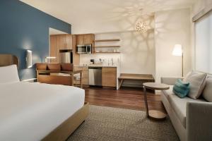 a room with a bed and a kitchen with a couch at Element by Marriott Pooler Savannah Airport in Savannah