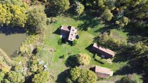 an aerial view of a house on a hill next to a river at maison campagne in Souesmes