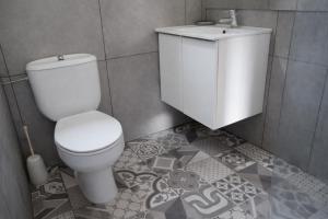a bathroom with a white toilet and a sink at Zaks House Valle San Lorenzo in Arona +35 photos