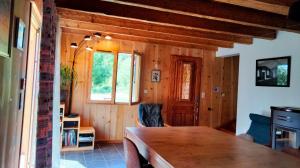 a dining room with a table and a window at gîte l'écureuil roux in LʼArgentière-la-Bessée