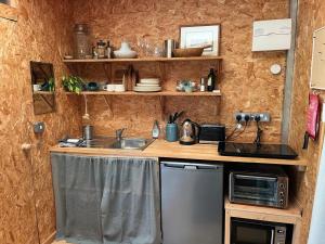 a small kitchen with a sink and a microwave at Meadows - Eco Retreat in Bitton +22 photos