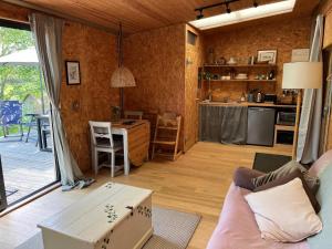 a living room with a couch and a table at Meadows - Eco Retreat in Bitton