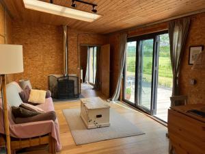 a living room with a couch and a fireplace at Meadows - Eco Retreat in Bitton