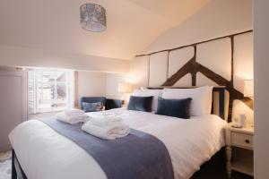 a bedroom with a large bed with towels on it at Lowcross House in Whitchurch