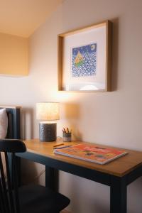 a desk with a lamp and a book on it at Lowcross House in Whitchurch