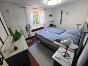 a bedroom with a bed and a table with a lamp at Ferienhaus Mia in Neumagen-Dhron