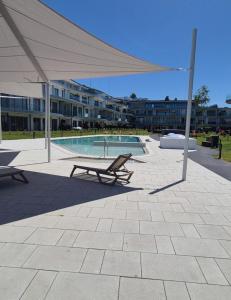 a pavilion with a picnic table and a pool at Waterfront studio in Balatonszemes