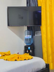 a view of a bed with a bottle of water at ML STUDIO with Rooftop, Free wifi, Free Parking in Nakuru +14 photos