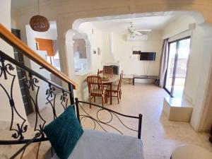 a living room with a kitchen and a dining room at Miltos beach House in Larnaca