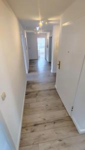 an empty hallway with wood floors in a house at Penthouse am Kurparkweiher in Bad Schwalbach