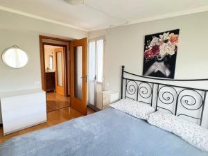 a bedroom with a blue bed and a painting on the wall at 4VENTI by LigurianLife in Vallebona
