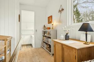 a home office with a desk and a window at Cottage Near Forest And Beach in Glesborg
