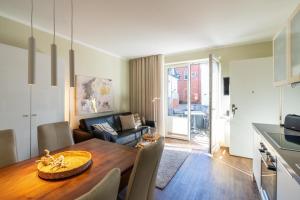 a kitchen and a living room with a dining room table at Wittehuus Wohnung 1 in Borkum