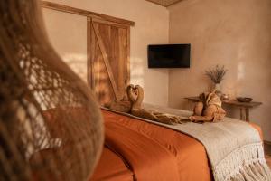 a bedroom with a bed with stuffed animals on it at Villa Kampung in Gili Islands
