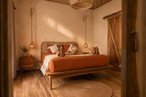 a bedroom with a bed with cats on it at Villa Kampung in Gili Islands +10 photos
