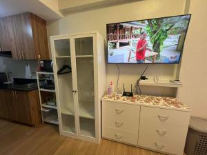 a living room with a tv on a wall at Loop Towers by Vista Residences in Pontud