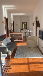 a living room with a couch and a table at Sul fiume di Varallo in Varallo