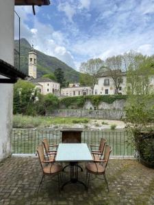 a table and chairs sitting on a brick patio at Sul fiume di Varallo in Varallo