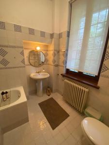 a bathroom with a sink and a mirror and a tub at Sul fiume di Varallo in Varallo +14 photos