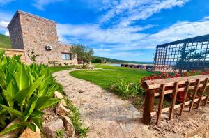 a wooden bench sitting in front of a building at VILLA DEMETRA in Kissamos