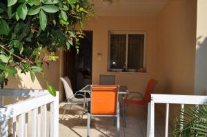 a dining room with orange chairs and a table at Sunset Garden Villa in Perivolia