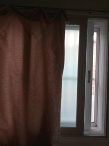 a window with a curtain in front of it at Kseashorehouse in Nŏmŏ