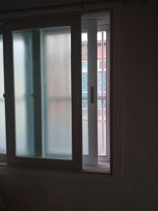 an open window with a view of a building at Kseashorehouse in Nŏmŏ