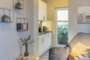 a living room with a couch and a window at Pier17 Appartement 2 in Borkum