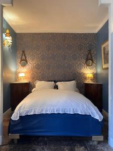 a bedroom with a large bed with two night stands at manoir de Rivières in Rivières +7 photos