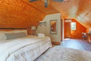 a bedroom with a bed and a wooden ceiling at Blue's Barn in Nellysford