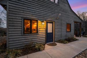 a house with a blue door on the side of it at Blue's Barn in Nellysford