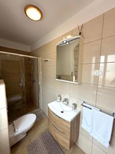 a bathroom with a sink and a shower and a toilet at Tea Rooms in Bale