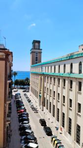 a street with cars parked in a parking lot at Le Suite dei Due Mari cucinino privato in Taranto +4 photos