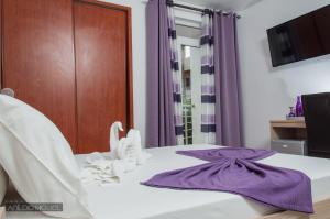 Ένα ή περισσότερα κρεβάτια σε δωμάτιο στο Hotel Cesaria