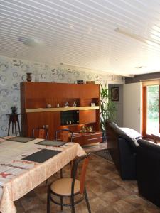 a living room with a table and a couch at Désir D'un Soir in Lessines