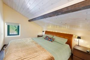 a bedroom with a large bed and a wooden ceiling at Villa Piuma in Finale Ligure