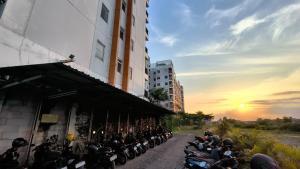a group of motorcycles parked next to a building at Student Castle Apartement by Dev's Room in Seturan