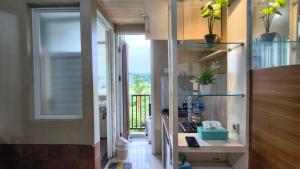 a room with a hallway with a door to a balcony at Student Castle Apartement by Dev's Room in Seturan