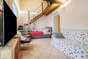 a living room with a couch and a bed at Villa Piuma in Finale Ligure